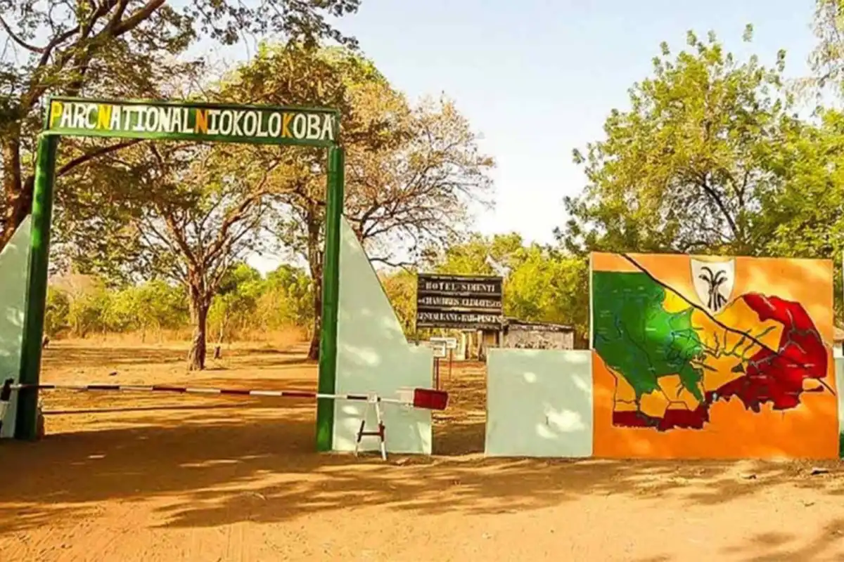 Entrance to Niokolo-Koba National Park, surrounded by trees and vegetation.